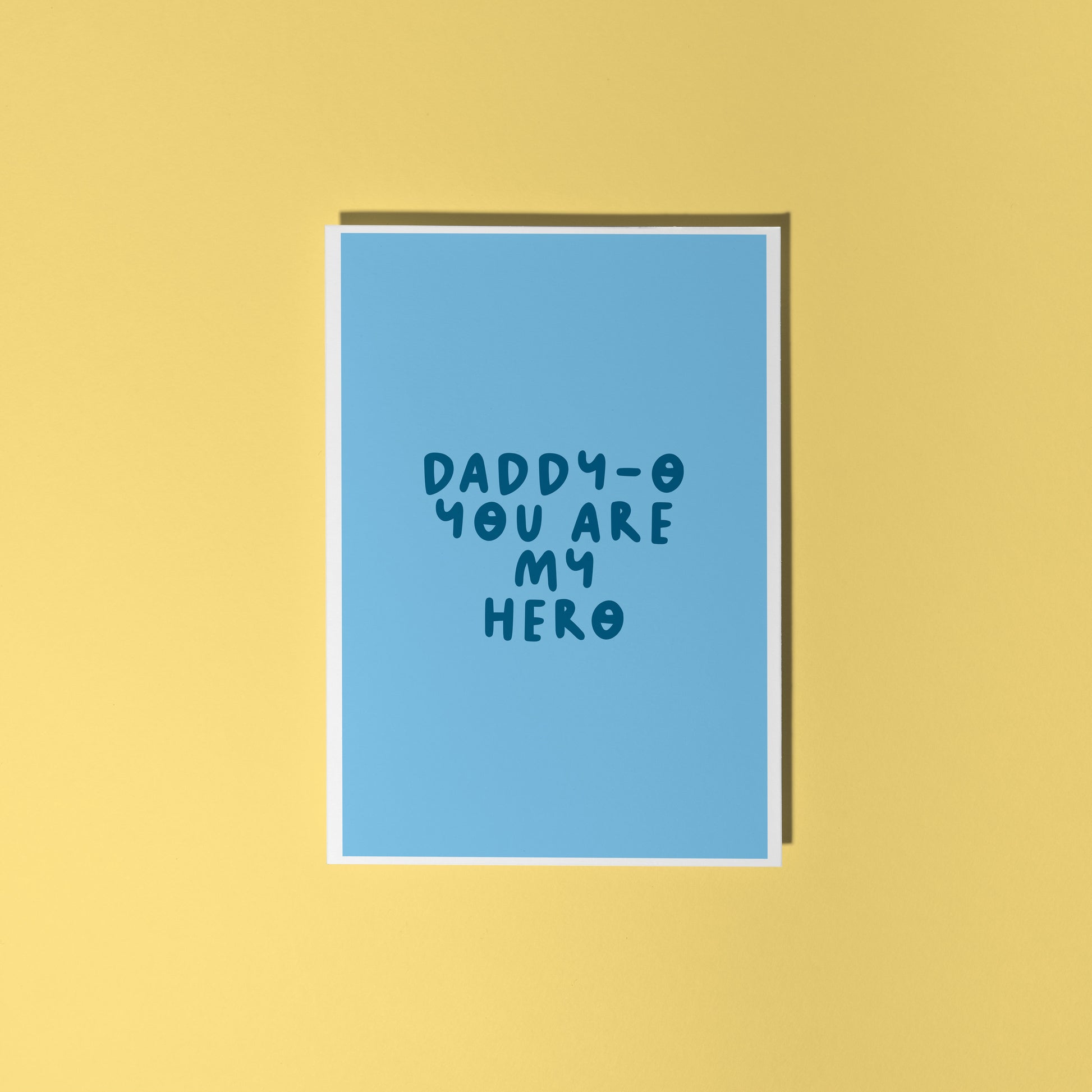 A blue greeting card with text that reads 'daddy-o you are my hero'.