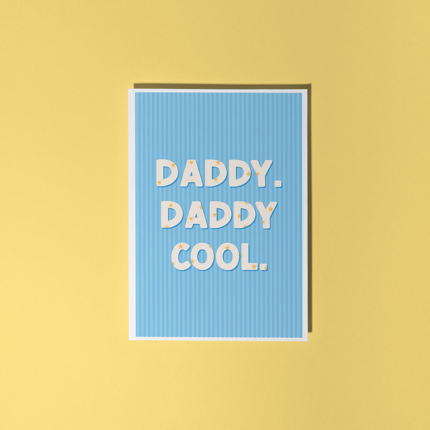 A blue greeting card with text that reads 'Daddy. Daddy Cool.' on the front with stars inside of the letters.