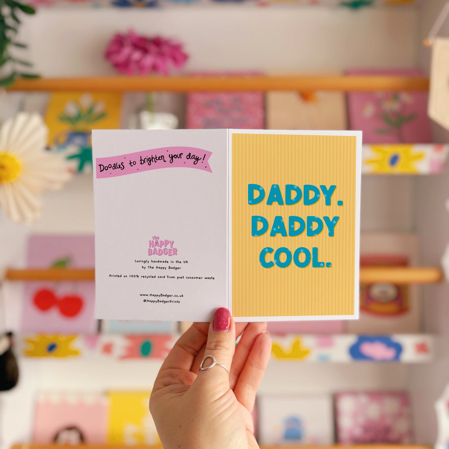 A yellow striped card, with bold blue text that reads 'Daddy. Daddy Cool.'