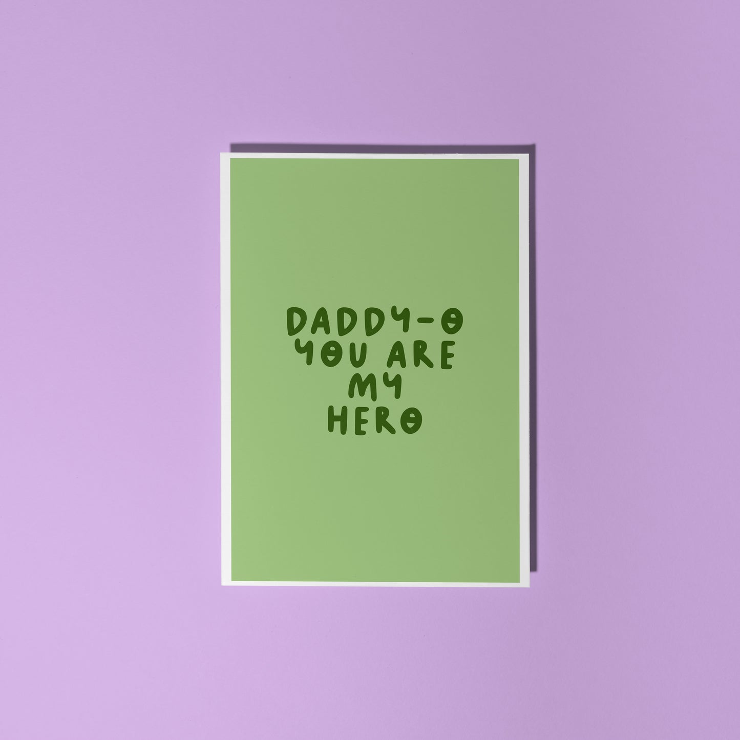 A green greeting card with text that reads 'Daddy-o you are my hero'.