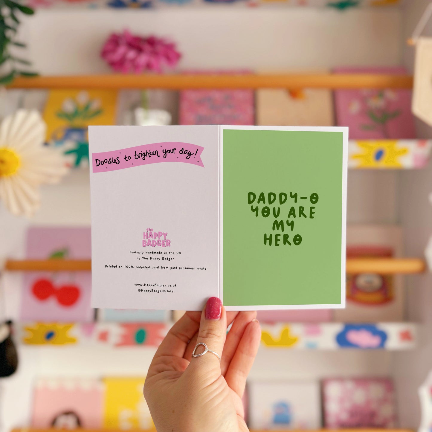 A green greeting card with text that reads 'Daddy-o you are my hero'.