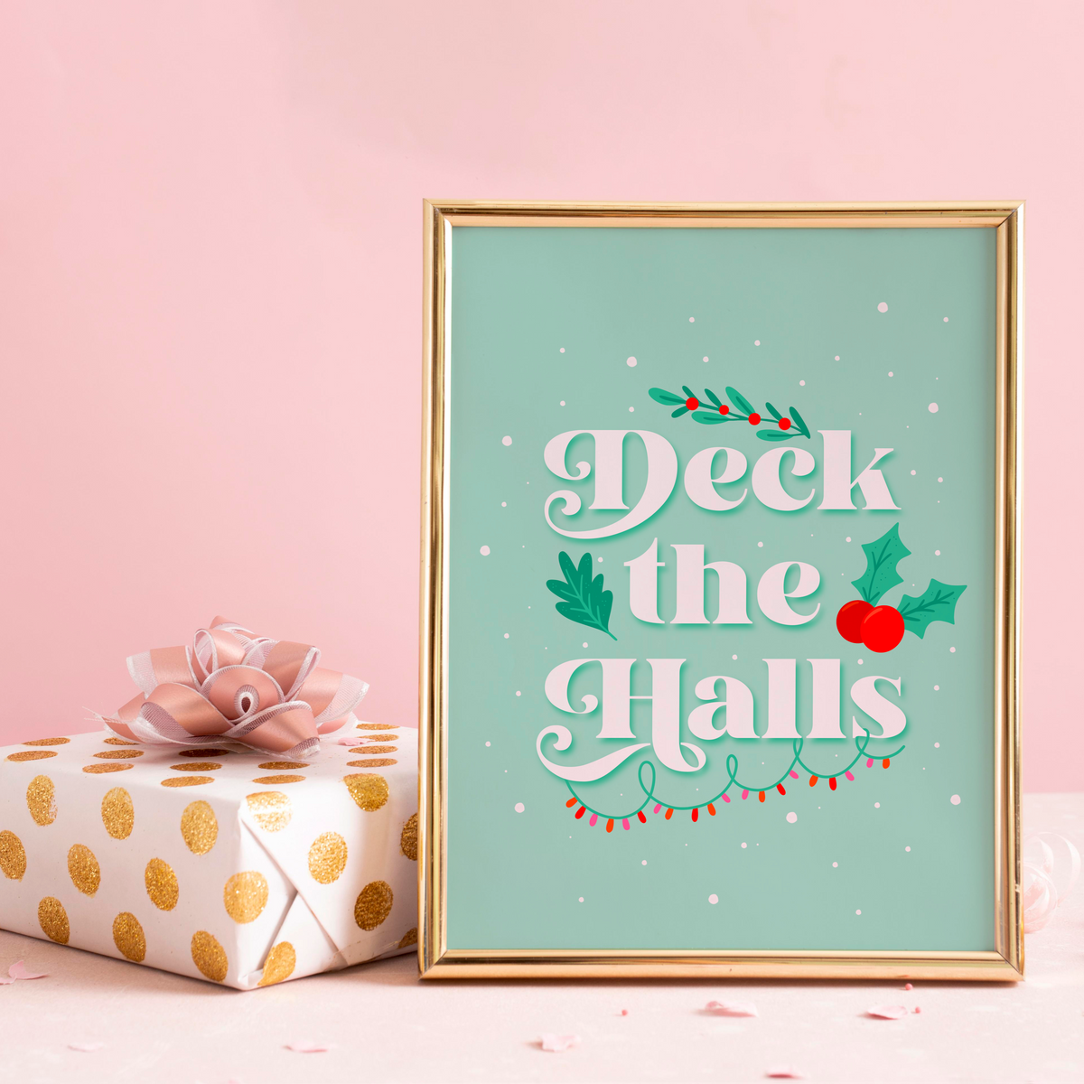 A pale green Christmas quote print, featuring the words 'deck the halls', surrounded by little Christmas themed doodles.