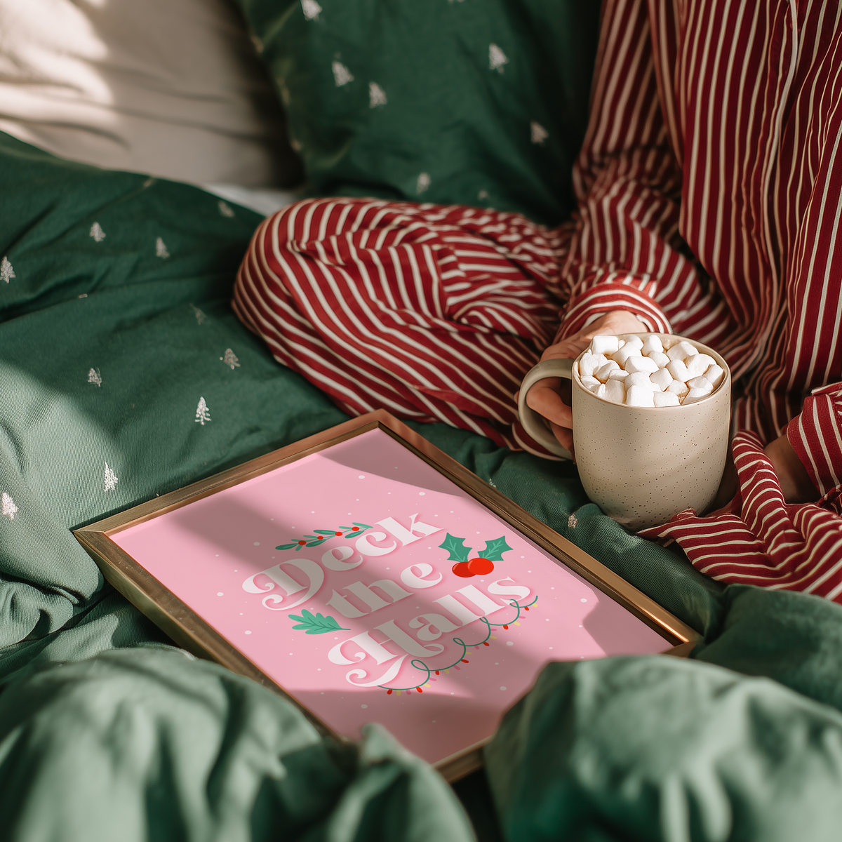 A pale pink Christmas quote print, featuring the words 'deck the halls', surrounded by little Christmas themed doodles.