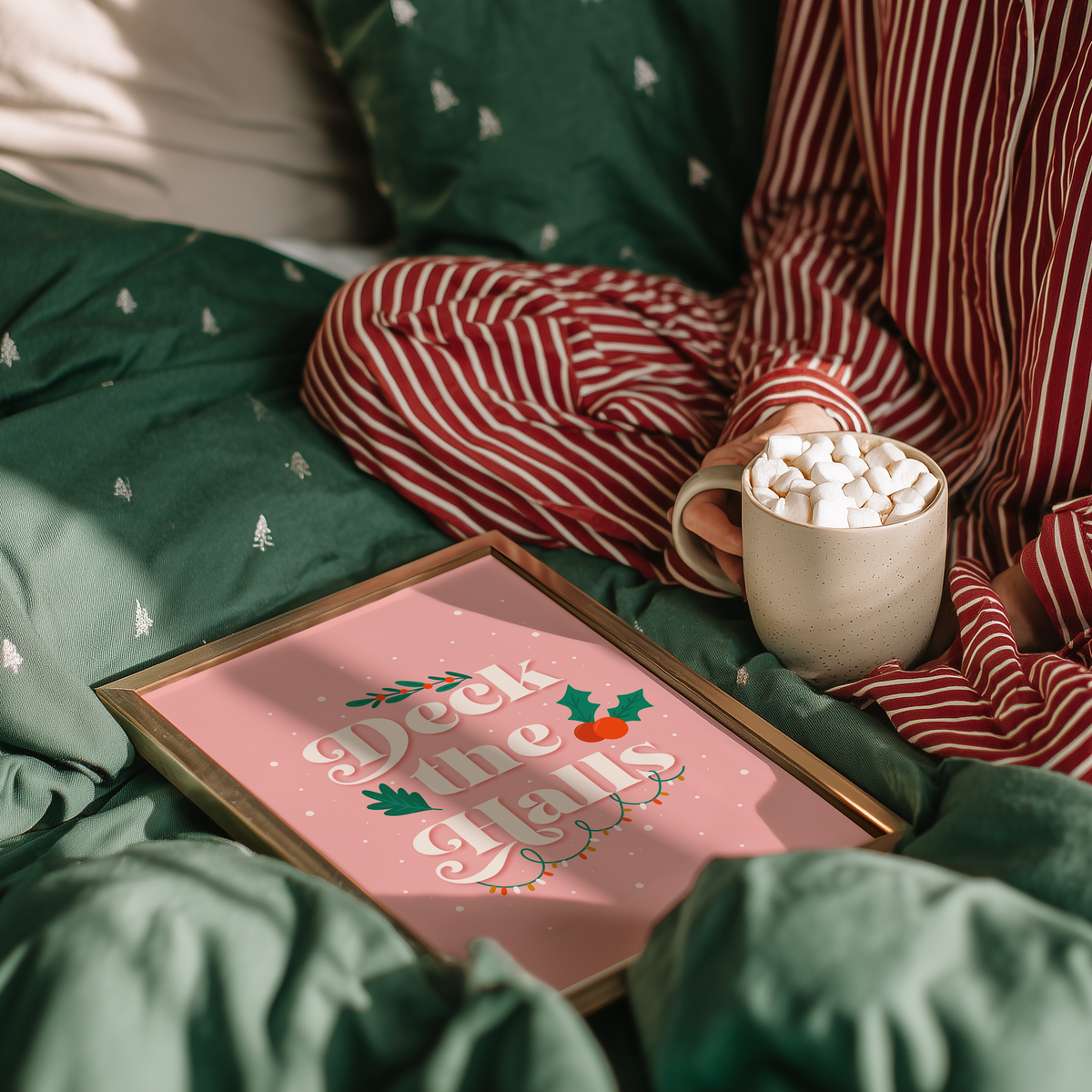A warm pink Christmas quote print, featuring the words 'deck the halls', surrounded by little Christmas themed doodles.