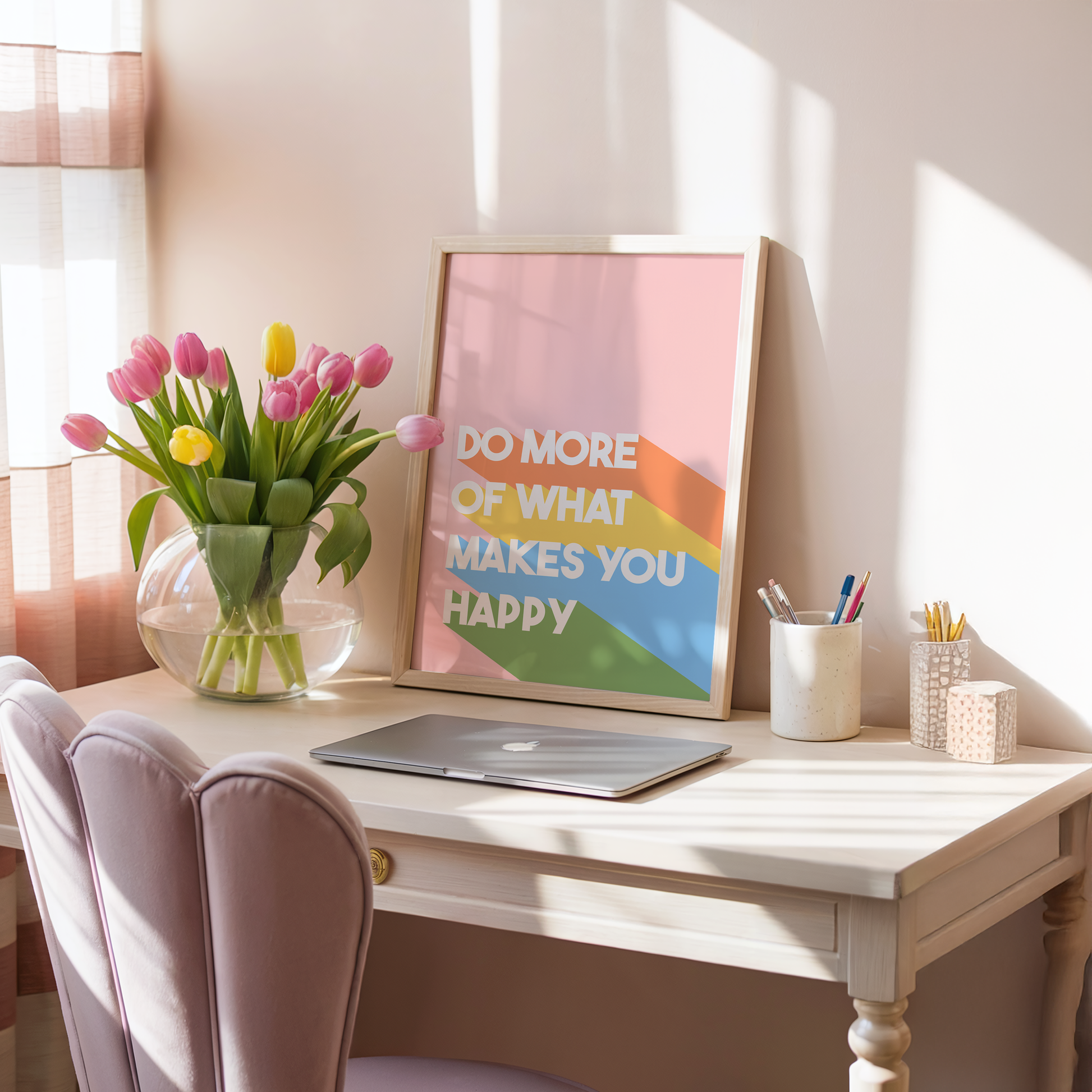 A pinky orange print with the words 'do more of what makes you happy' on, with brightly coloured stripes.