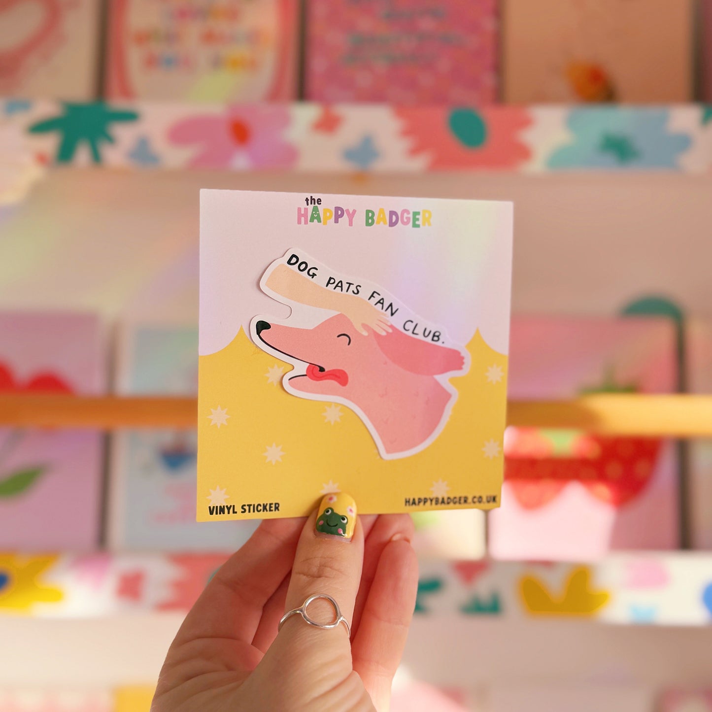 A waterproof sticker featuring an illustration of a dog with its tongue out and a hand patting its head. The text reads 'dog pats fan club'.