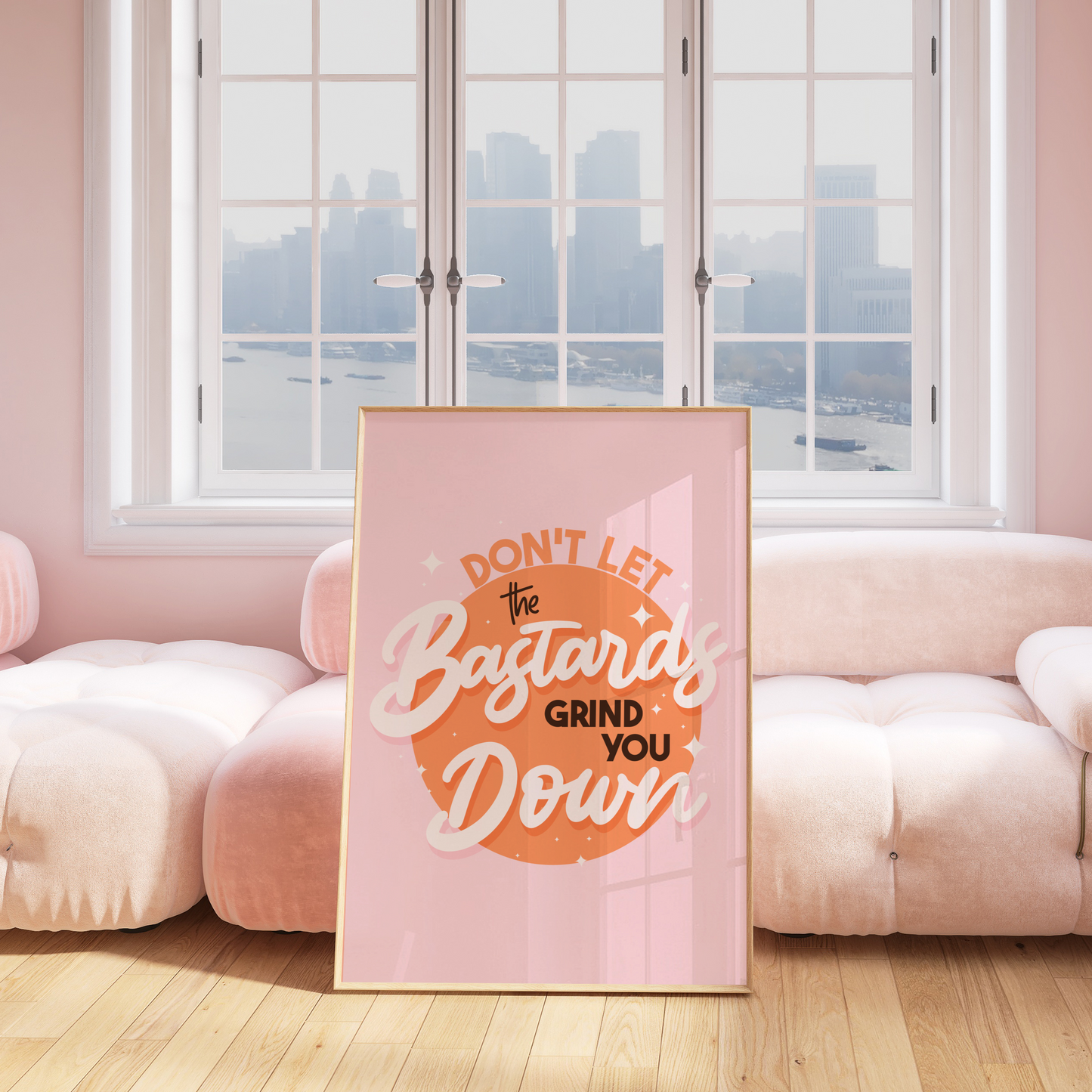 A bright pink and orange print showing a funny quote - don't let the bastards grind you down.