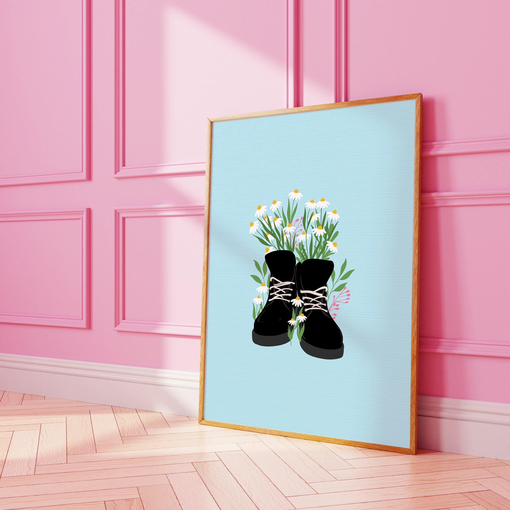 A bright blue print with an illustration of boots with daisies in them.