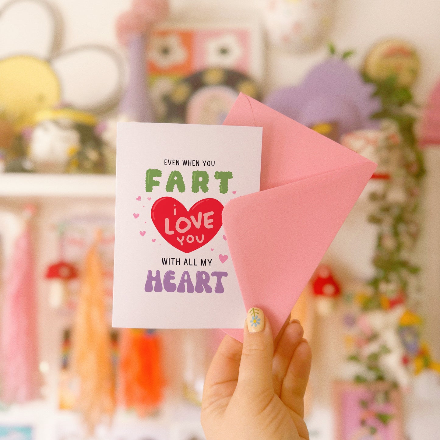 A funny quote love themed card, that says 'even when you fart, I love you with all my heart, in hand drawn lettering.