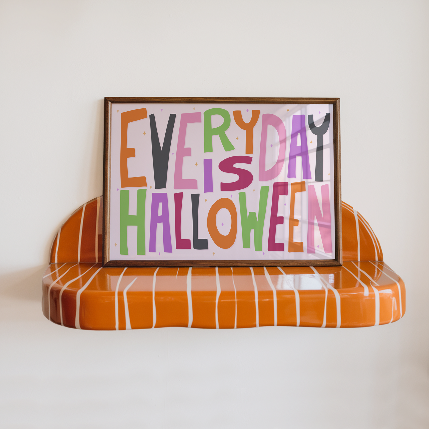 A typographic wall art piece reading “EVERY DAY IS HALLOWEEN” in colourful letters.