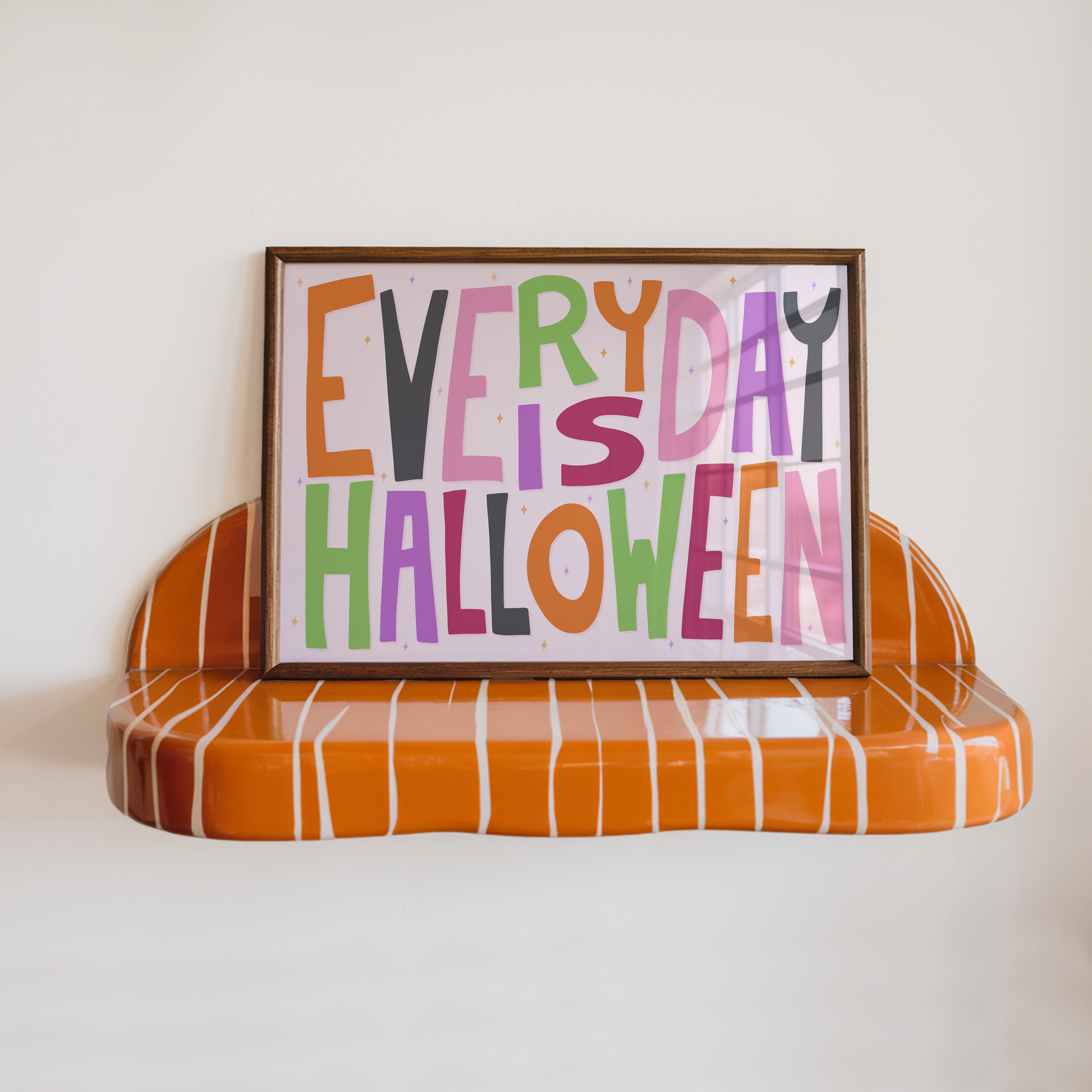A typographic wall art piece reading “EVERY DAY IS HALLOWEEN” in colourful letters.
