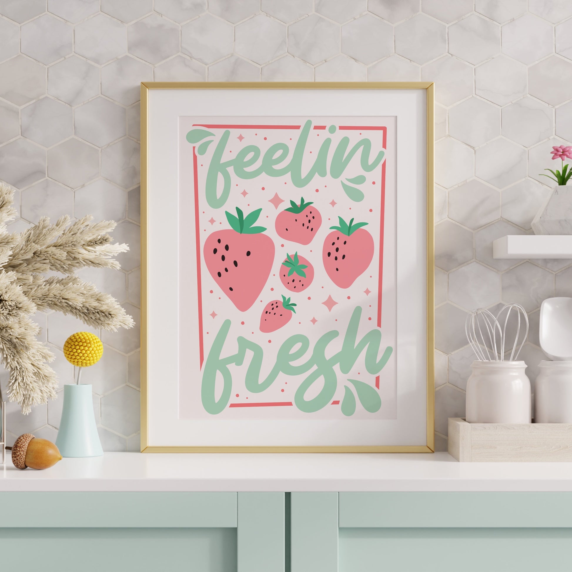 A bright print showing a cute illustration of strawberries against text saying feelin' fresh.