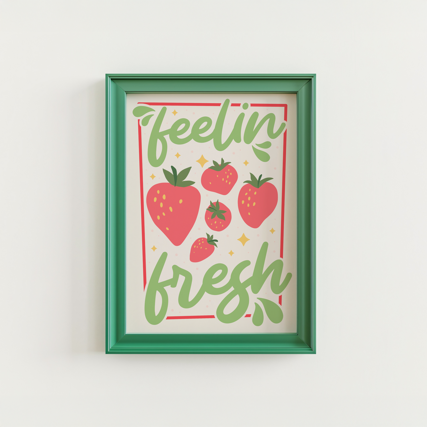 A colourful art print with the phrase 'feelin' fresh' surrounded by illustrations of strawberries, shown in a frame.