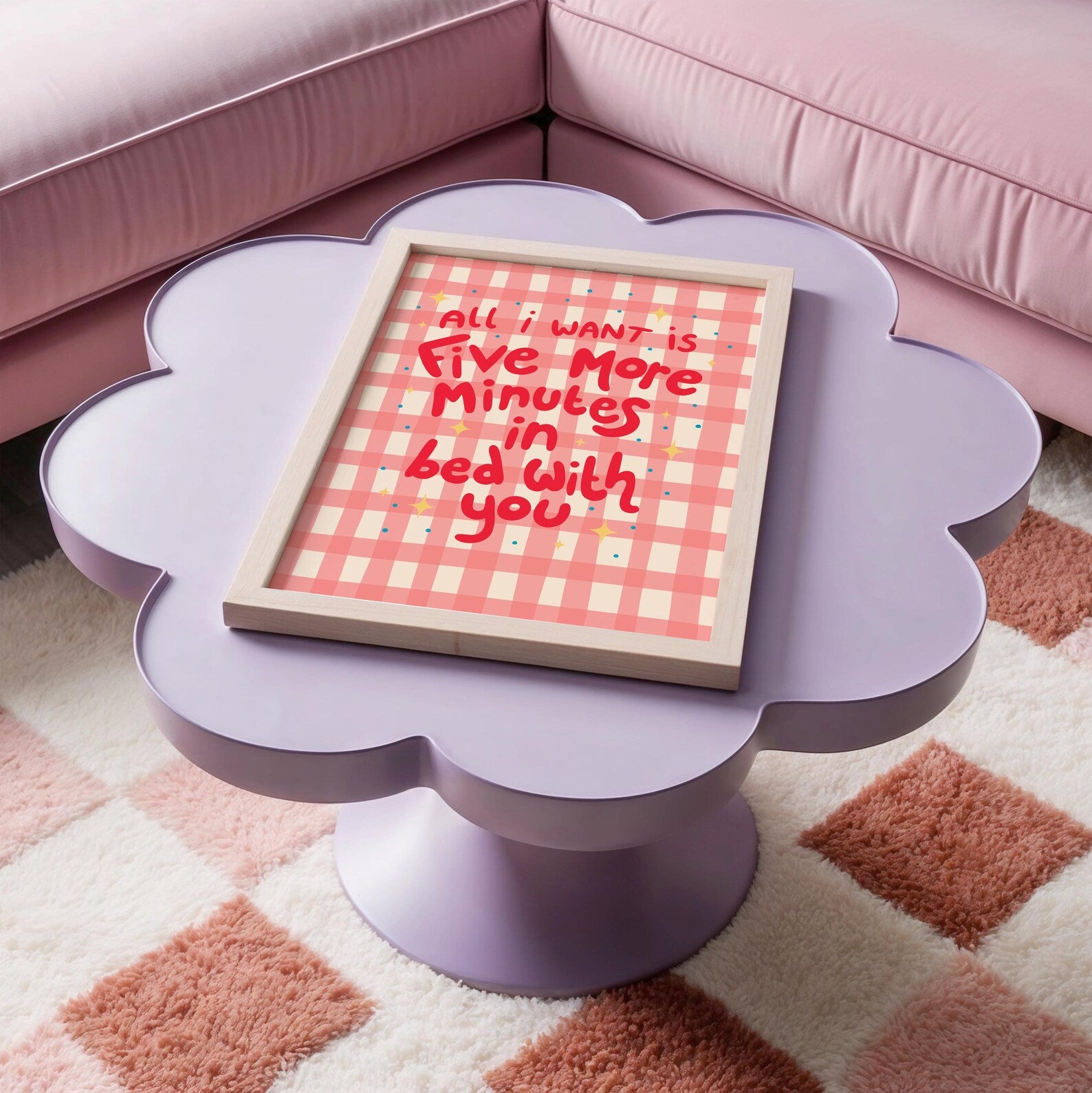 A pinky red checkered print with hand lettered text that says 'all I want is five more minutes in bed with you'.