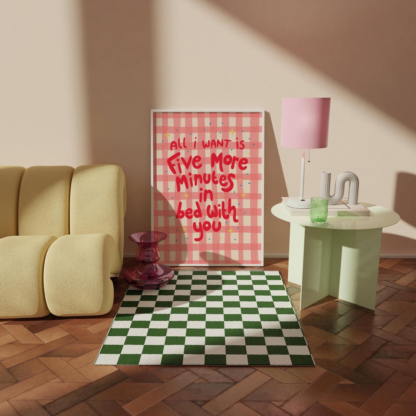 A pinky red checkered print with hand lettered text that says 'all I want is five more minutes in bed with you'.