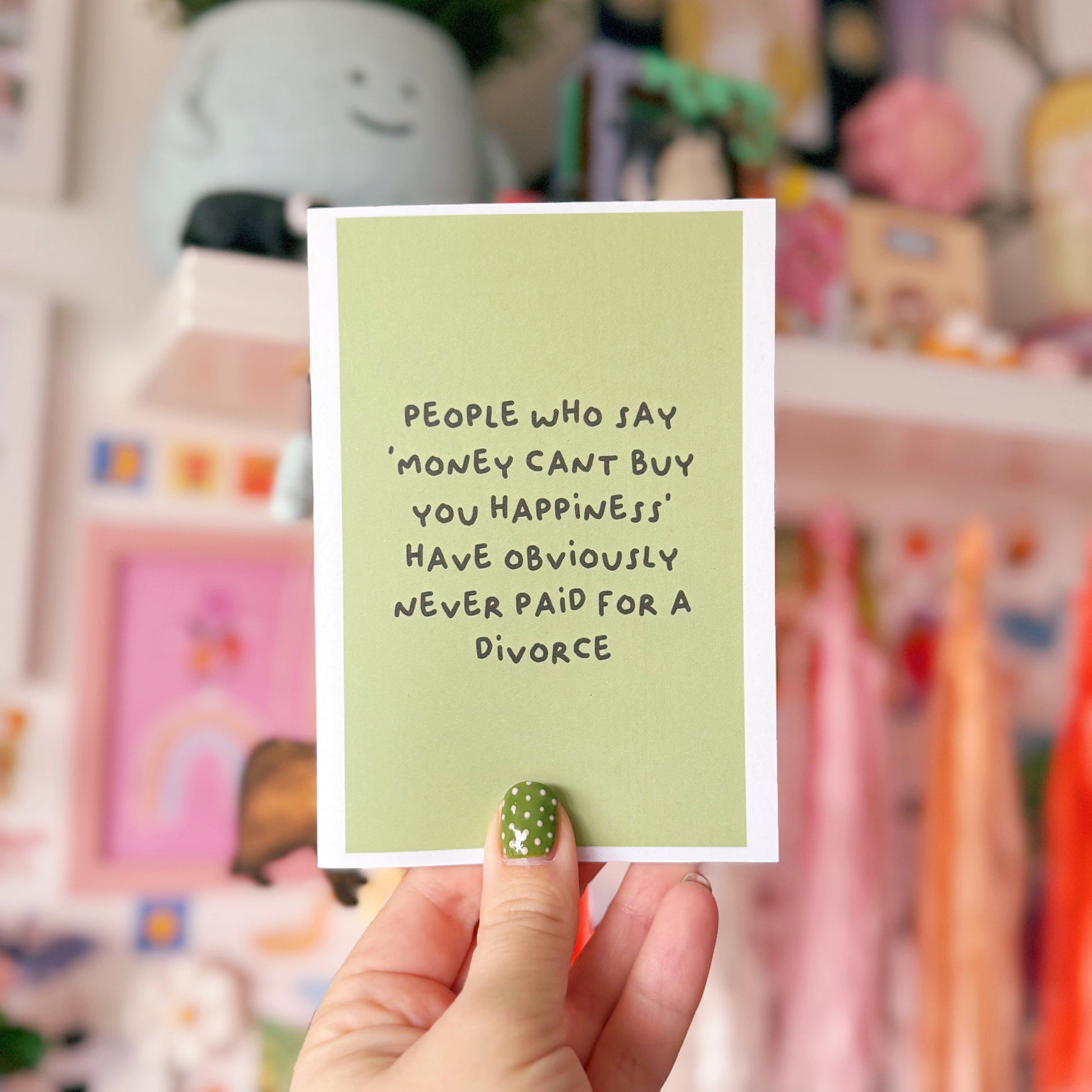 A green card with a funny quote about divorce on the front.