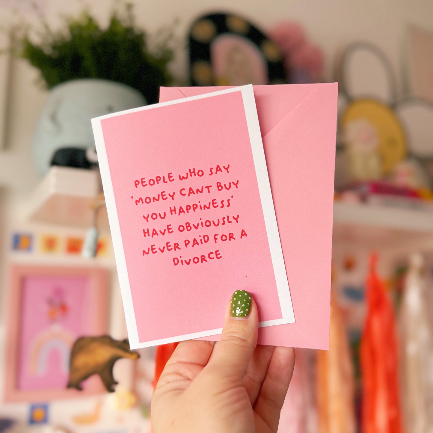 A pink card with a funny quote about divorce on the front.