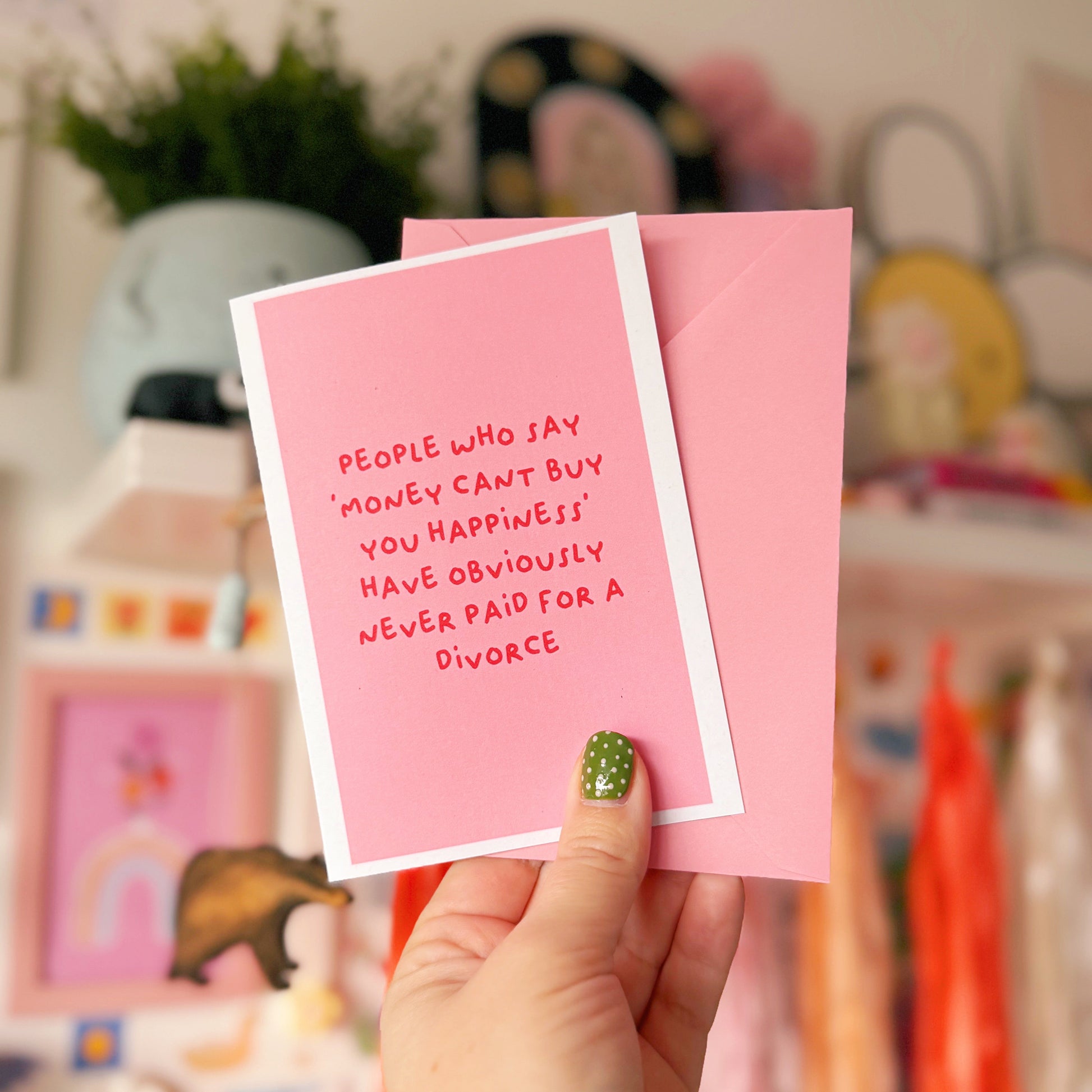 A pink card with a funny quote about divorce on the front.