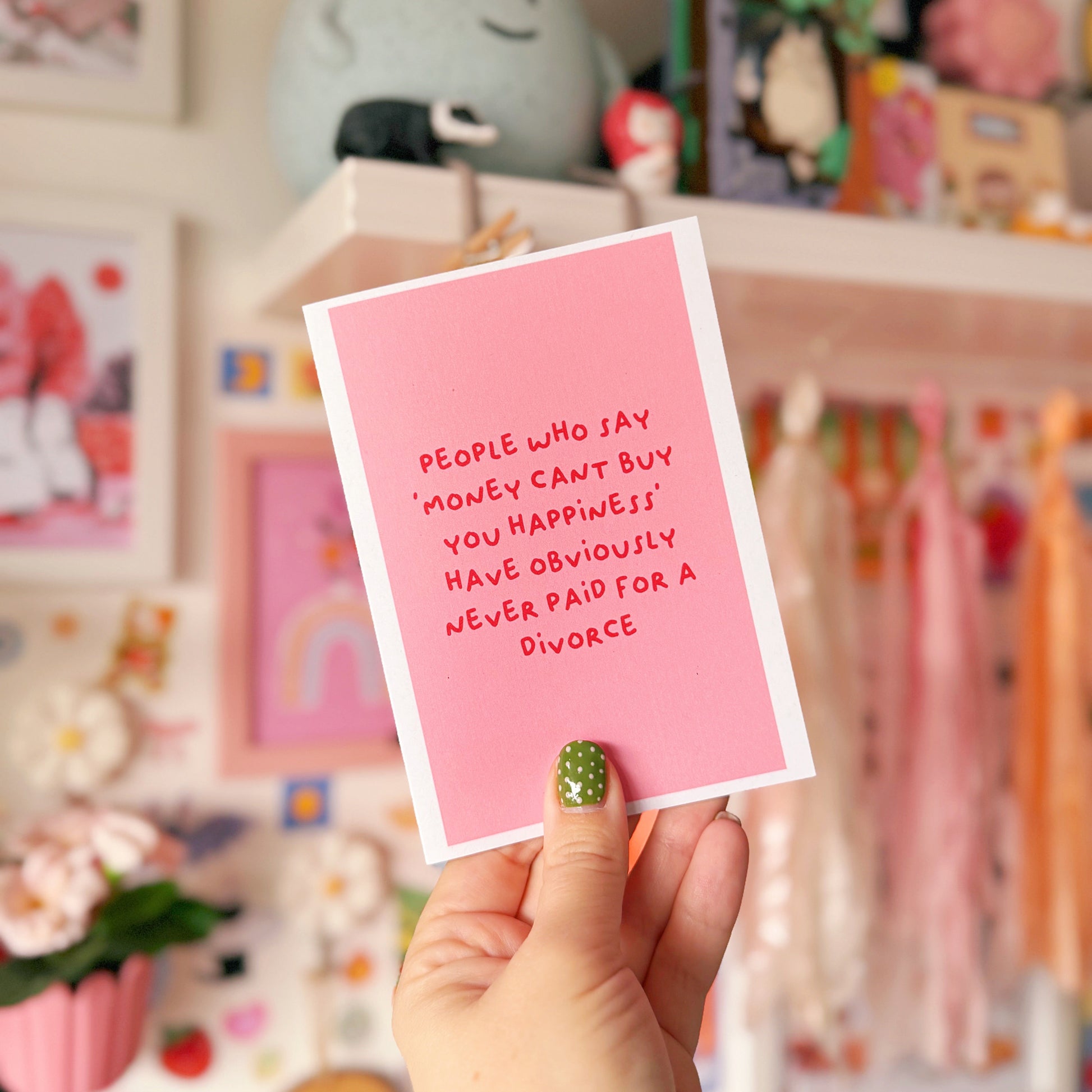 A pink card with a funny quote about divorce on the front.