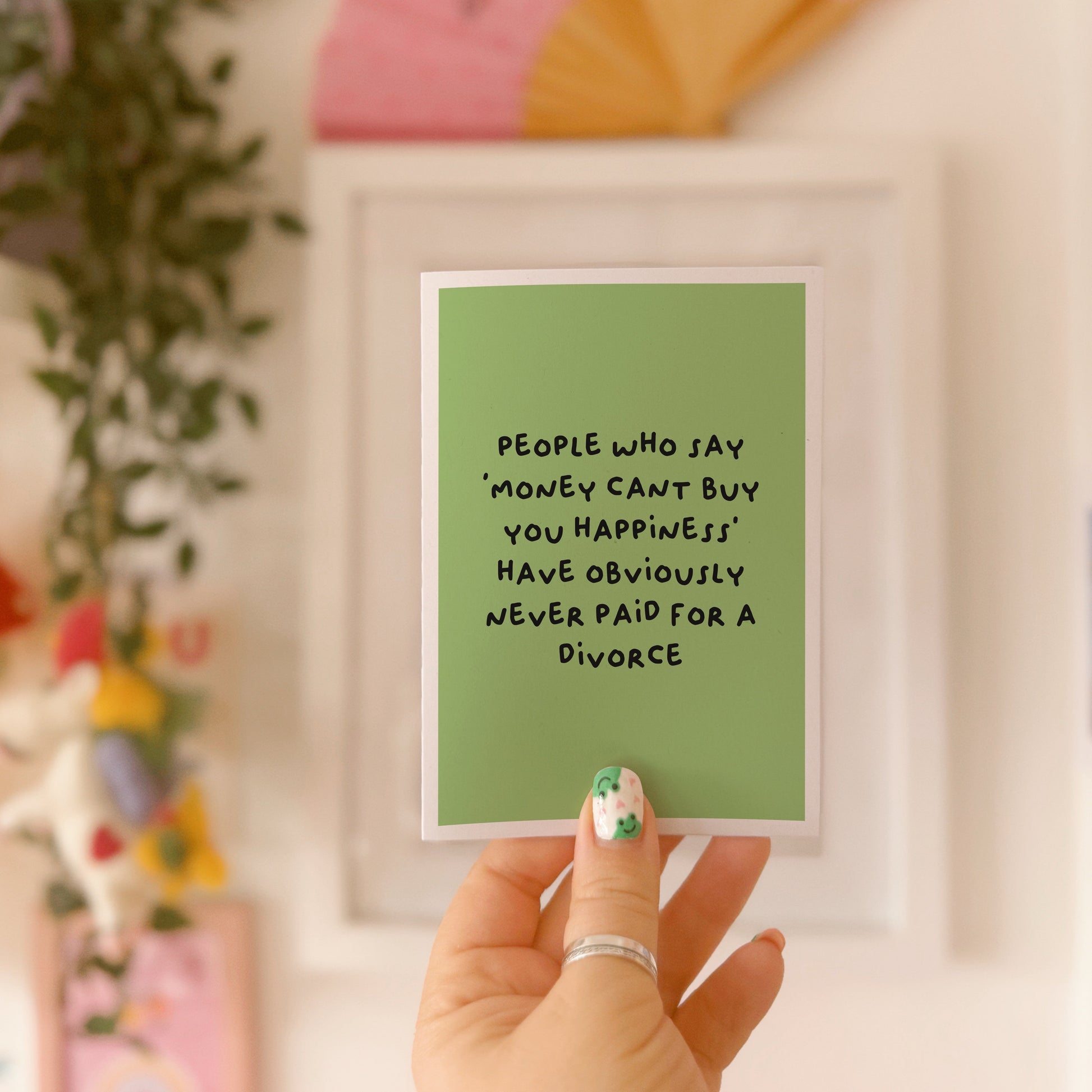 A green card with a funny quote about divorce on the front.
