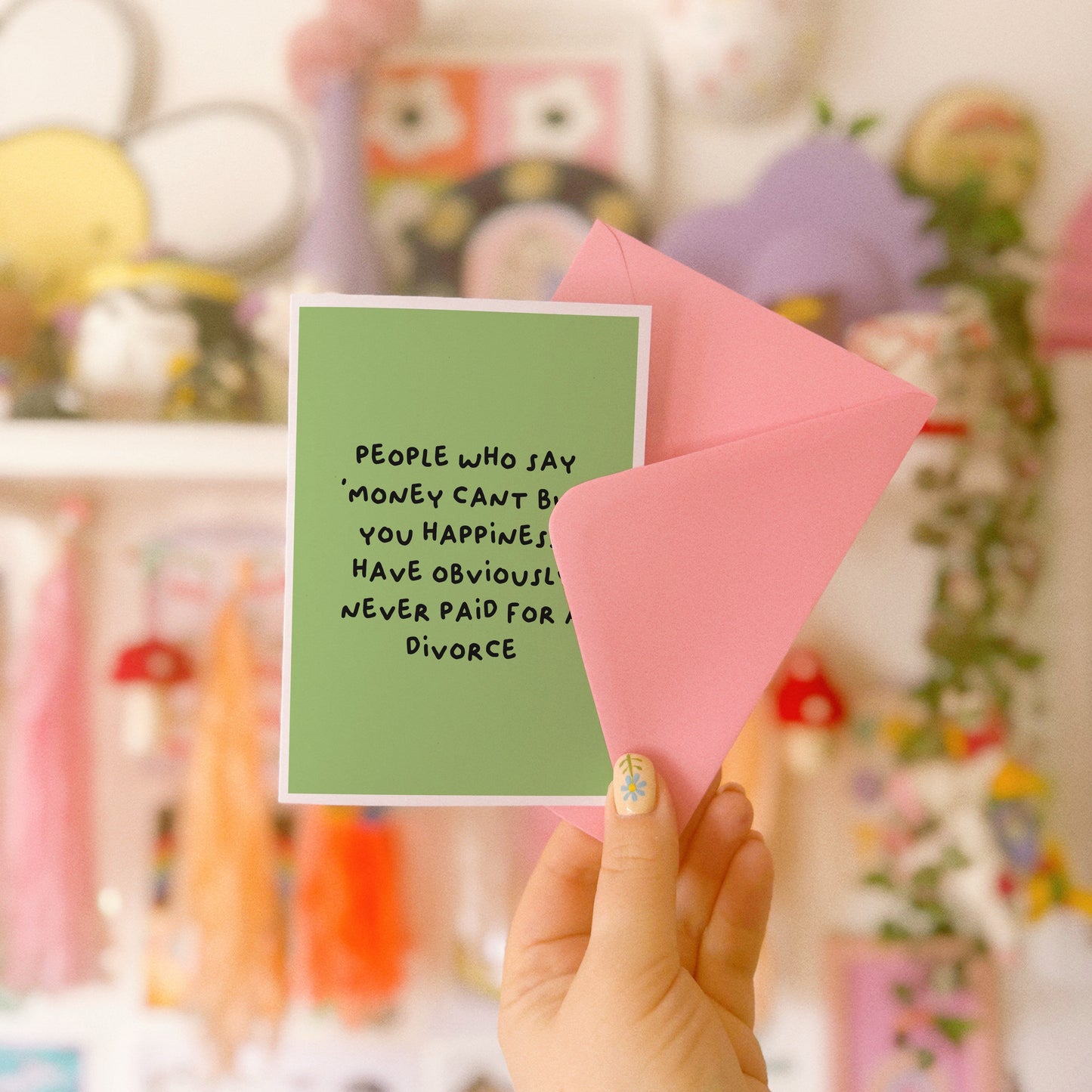 A green card with a funny quote about divorce on the front.