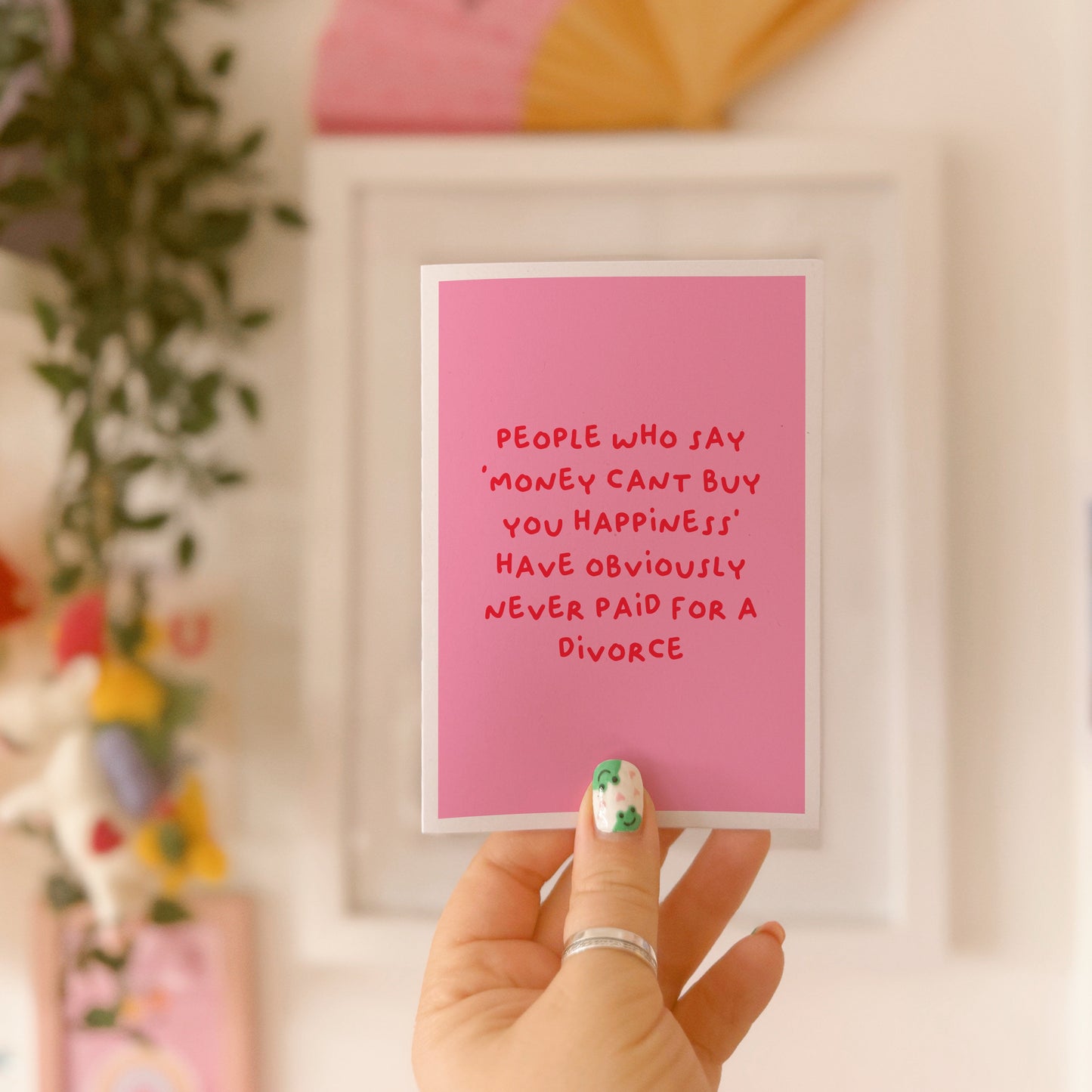 A pink card with a funny quote about celebrating getting divorced.