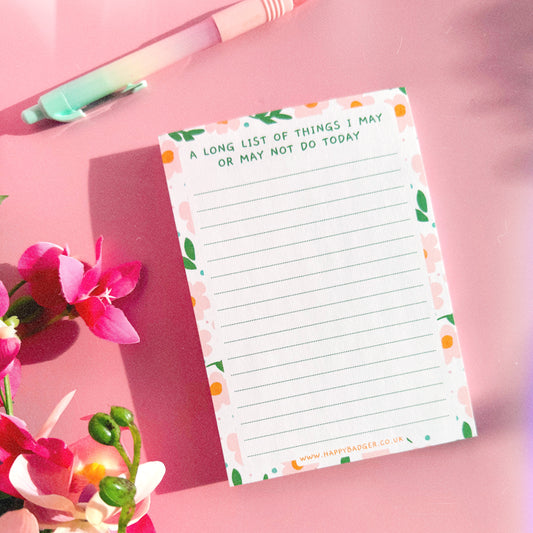 An image of a lined notepad, with a funny quote at the top and a colourful floral border.