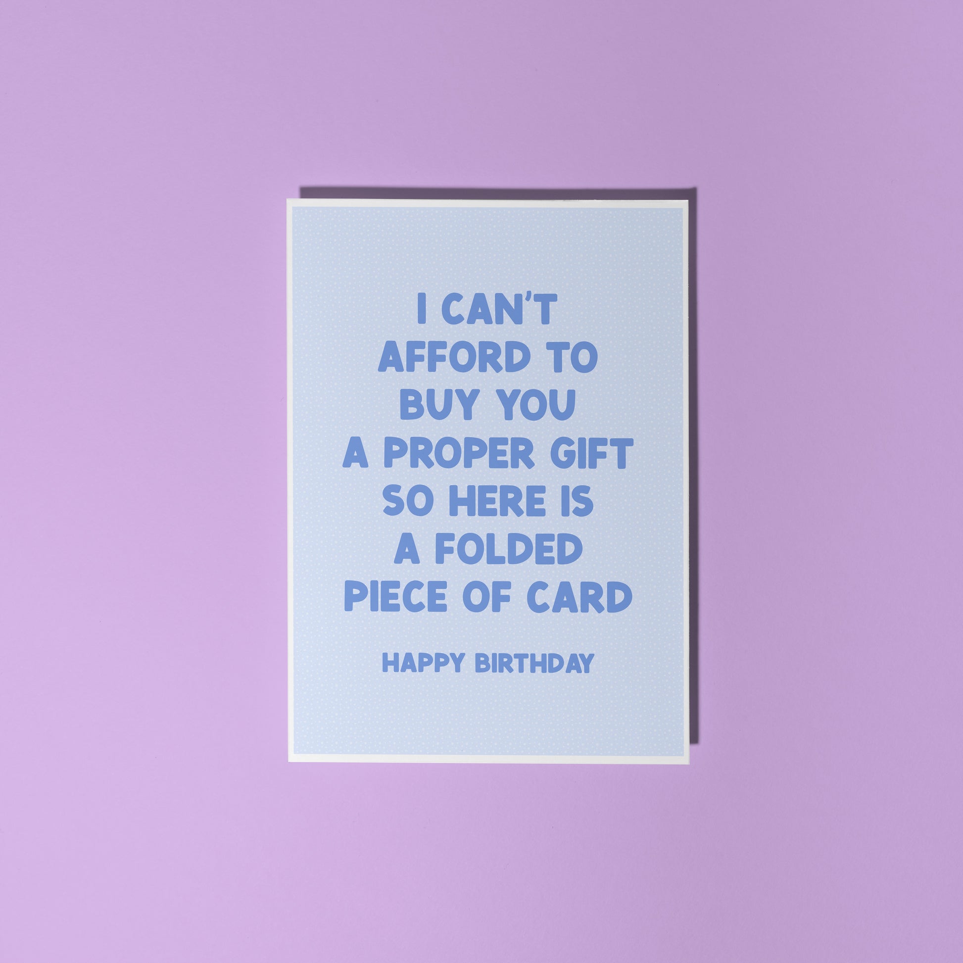 Light blue card with humorous birthday message on a purple background