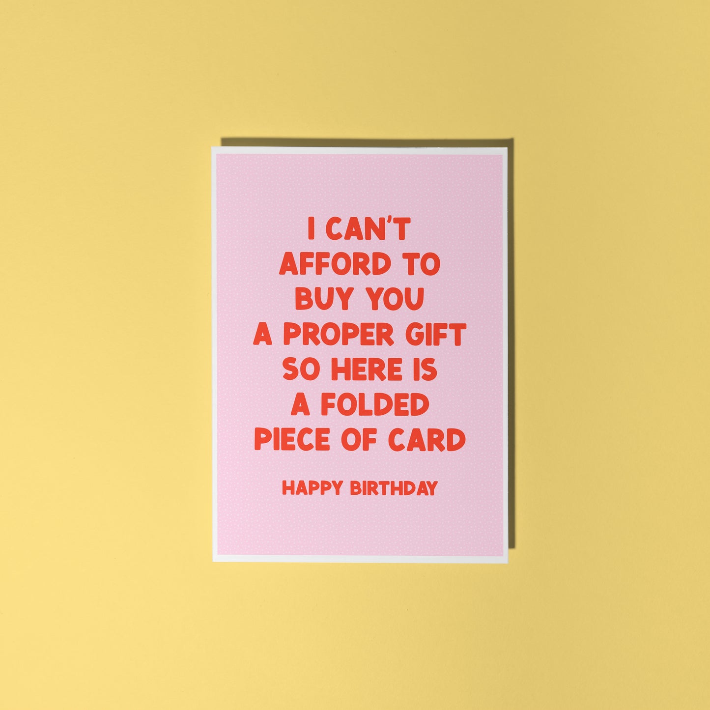 Pink card with red text on a yellow background