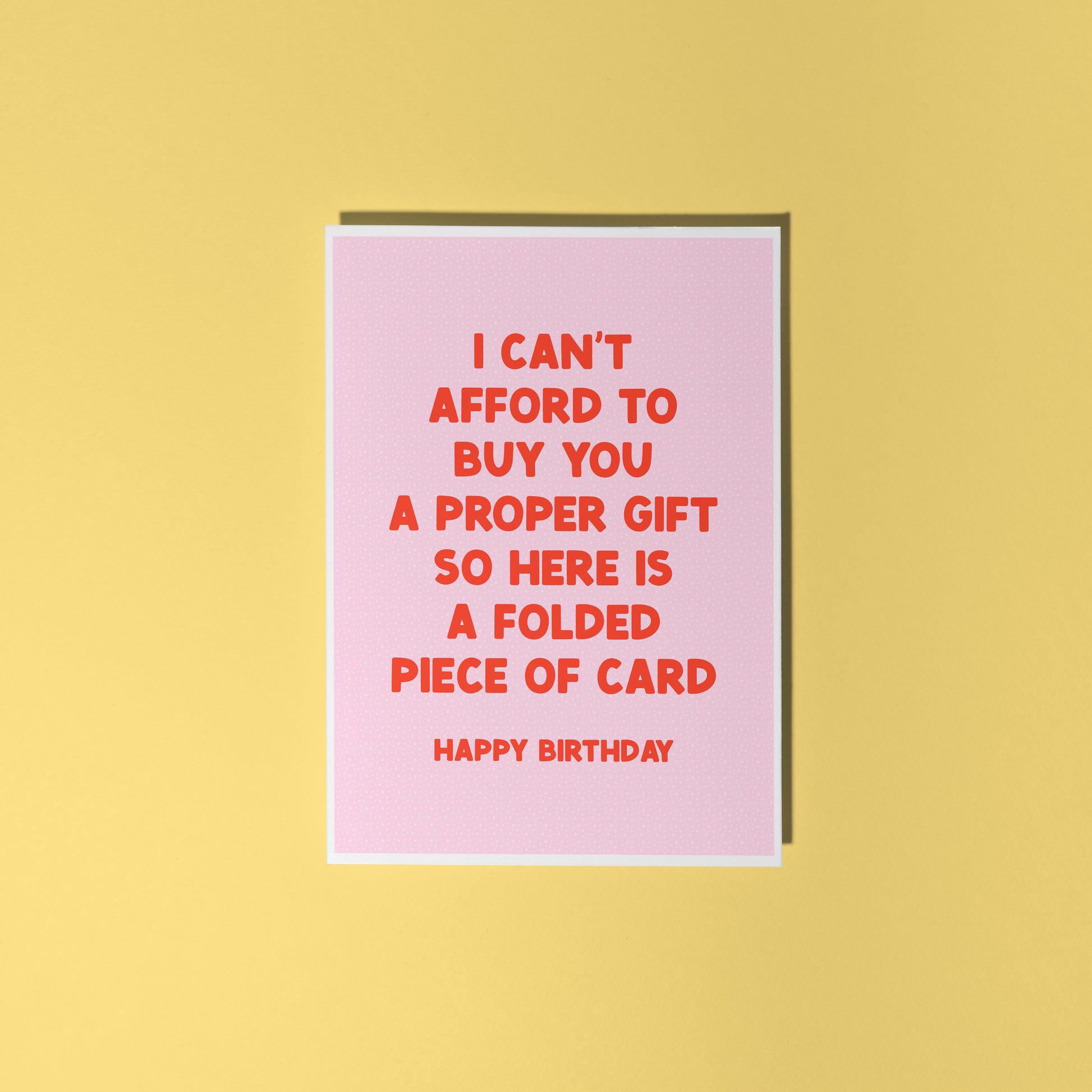 Pink card with red text on a yellow background