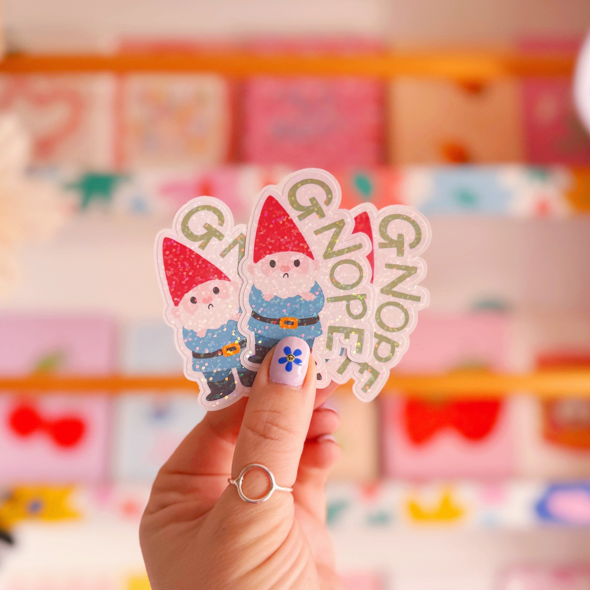 A holographic sticker of a grumpy garden gnome, and the word 'gnope' next to him.