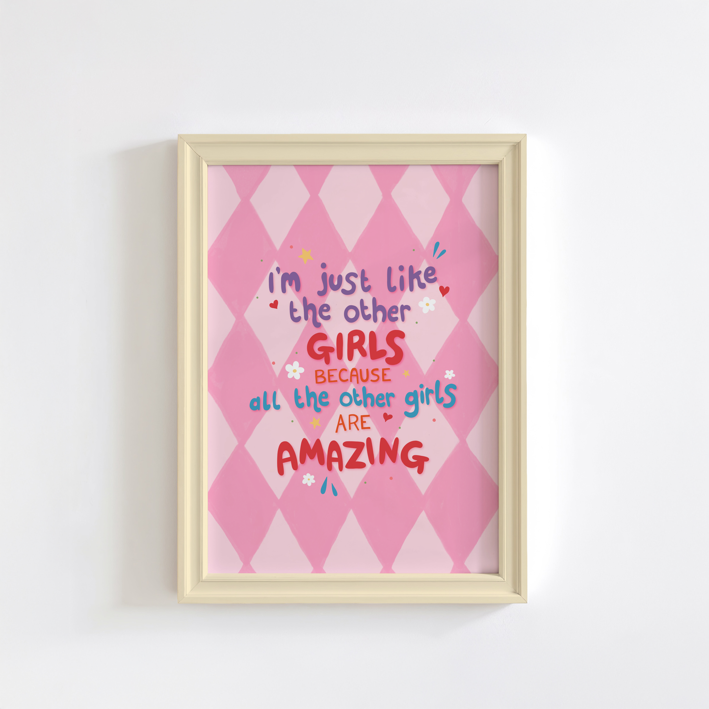 A pink harlequin patterned background with a female empowerment quote print in different coloured hand lettered text.
