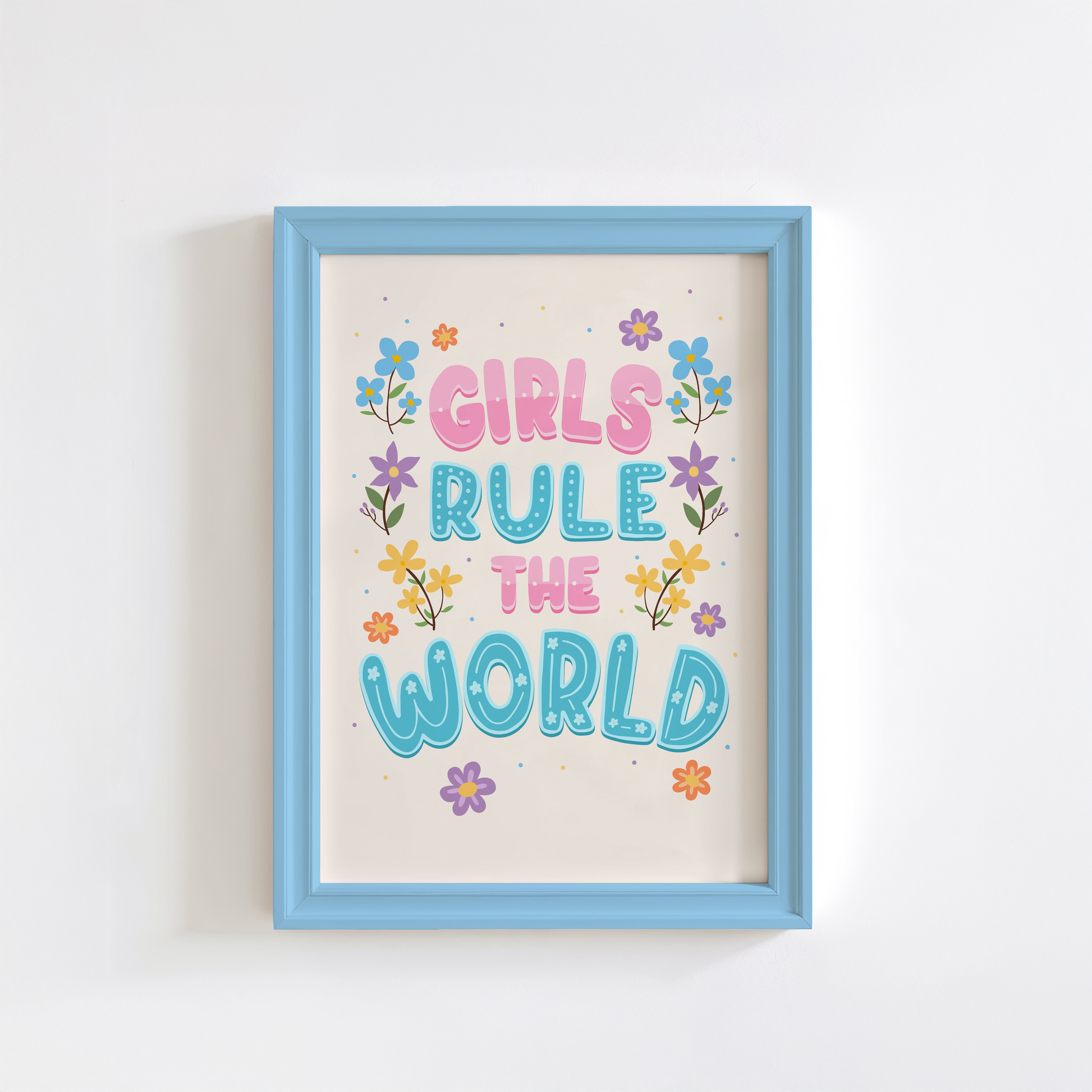 A hand lettered quote print, featuring the words 'girls rule the world' in pink and blue. Surrounded by colourful floral illustrations. 