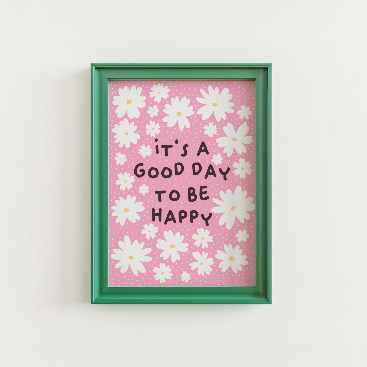 A pink print with several white daisies, surrounding a positivity message of 'it's a good day to be happy'.