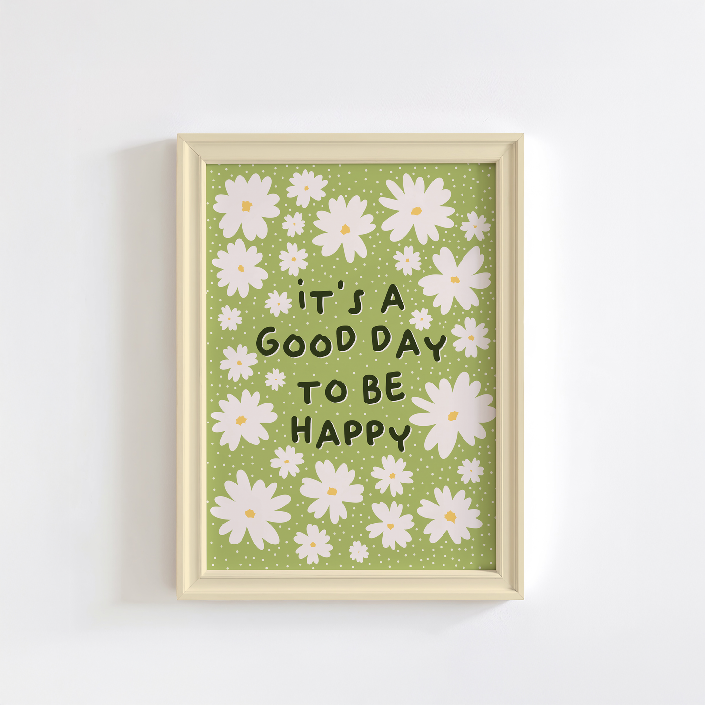 A green print with daisy illustrations and a quote that reads 'it's a good day to be happy'.