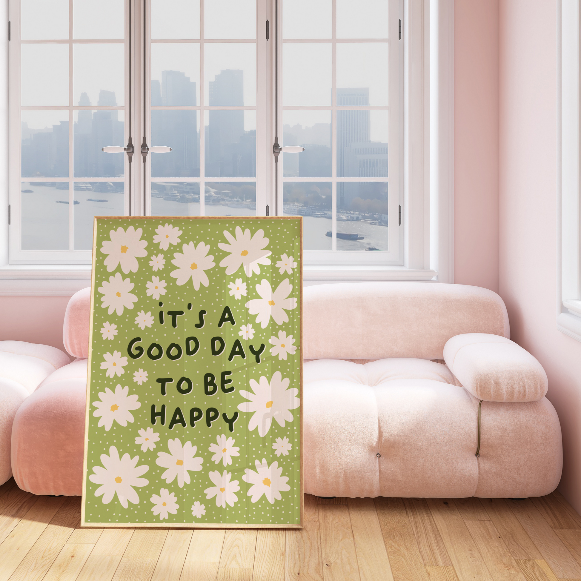 A green print with daisy illustrations and a quote that reads 'it's a good day to be happy'.