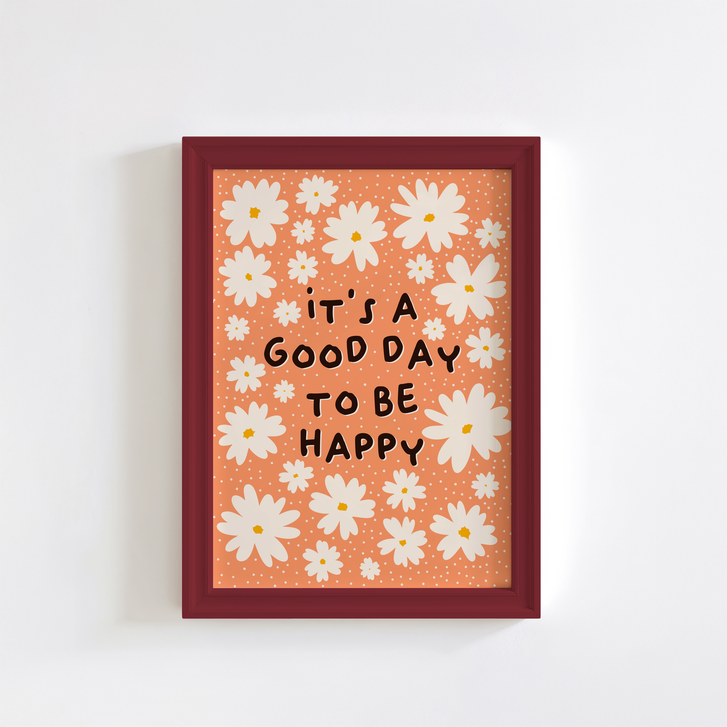 Orange wall art print with white daisies and 'it's a good day to be happy' quote.