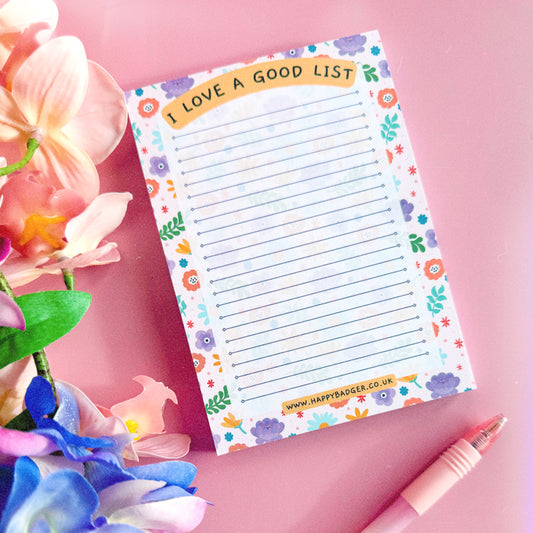 Image shows a floral patterned lined notepad, with text saying "I Love A Good List".