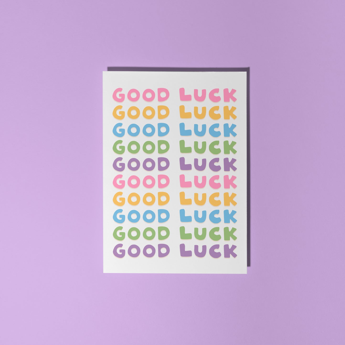 A colourful card with the words 'good luck' written on the front in several different colours.