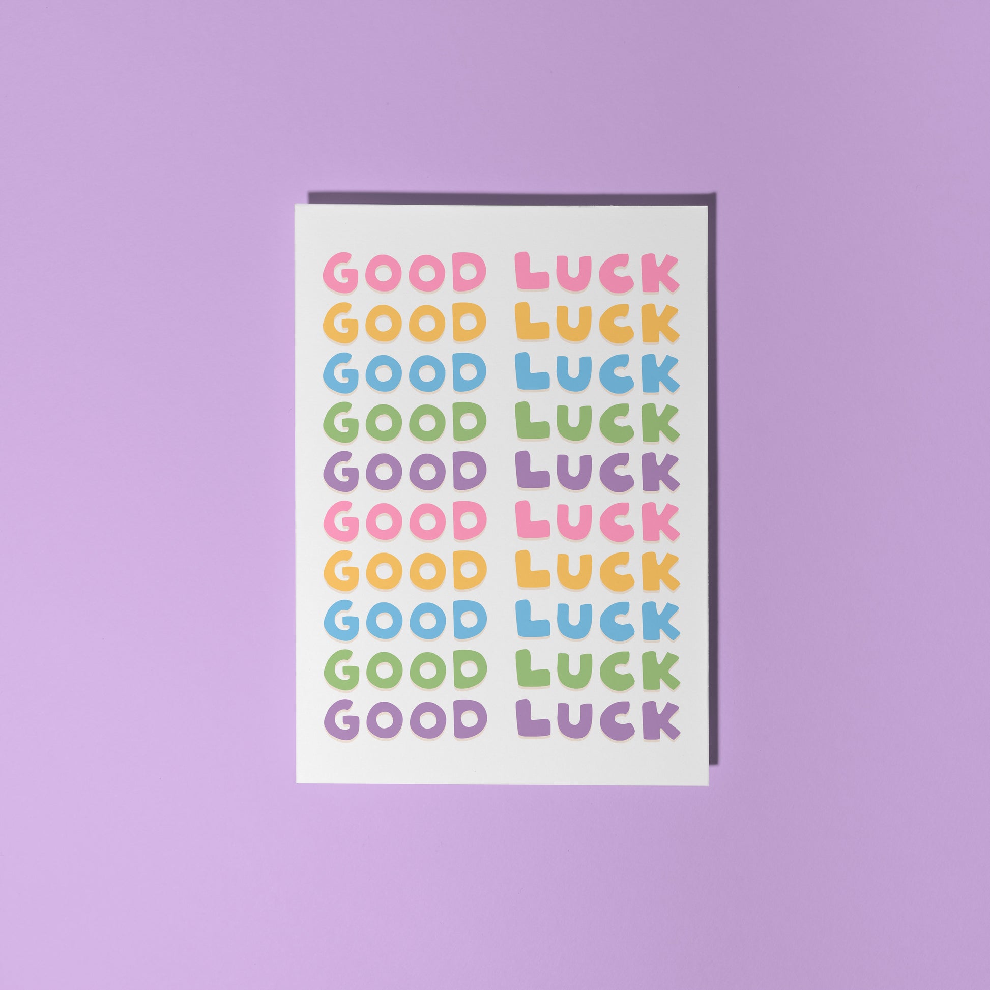 A colourful card with the words 'good luck' written on the front in several different colours.