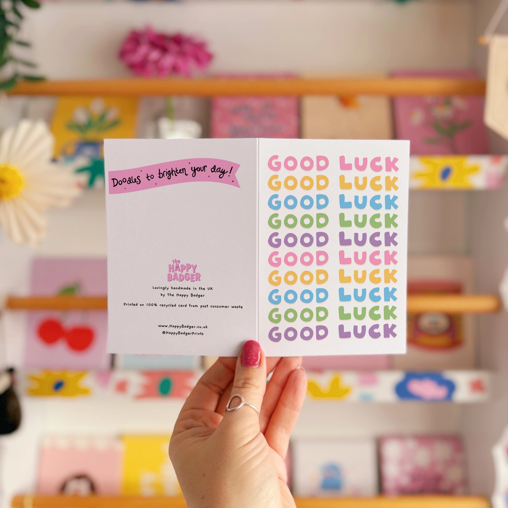 A colourful card with the words 'good luck' written on the front in several different colours.