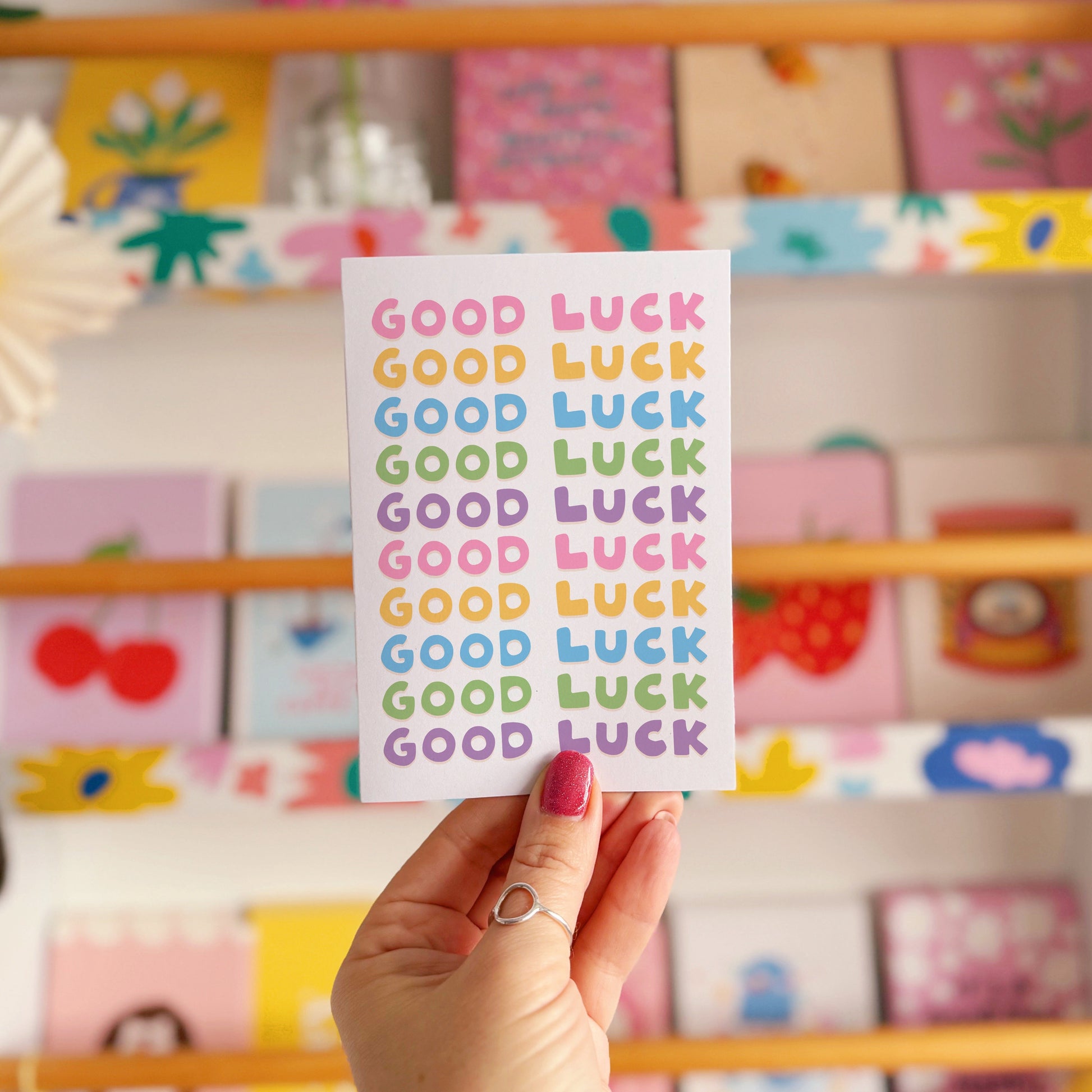 A colourful card with the words 'good luck' written on the front in several different colours.