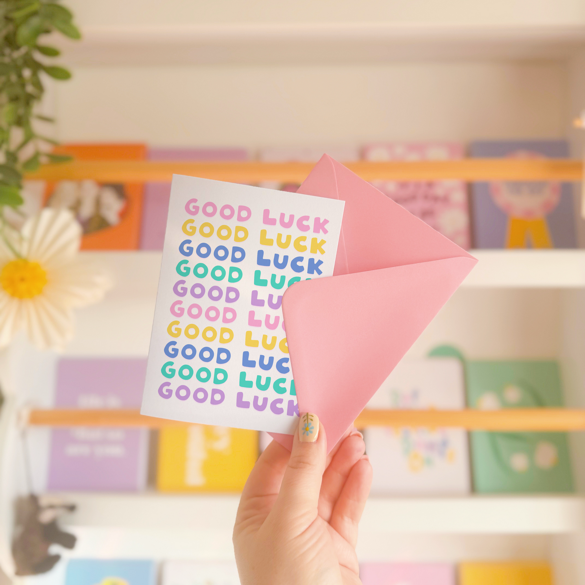 A greetings card, with the phrase 'good luck' repeated several times in colourful shades.