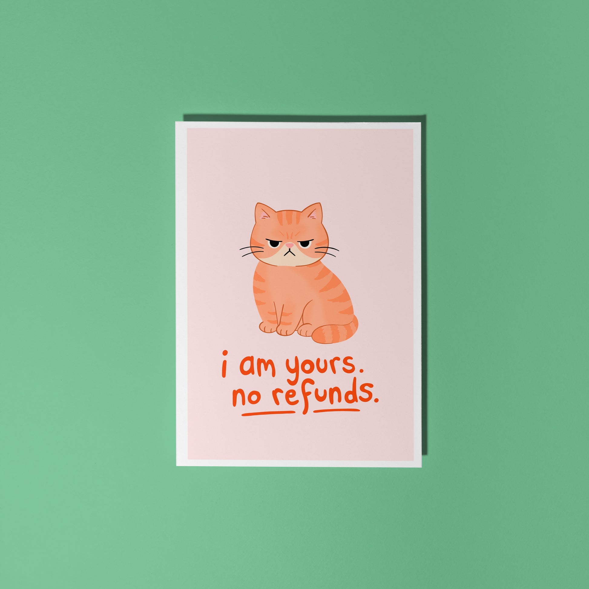 An illustrated card with a drawing of a grumpy orange cat, and words underneath that read 'I am yours, no refunds.'