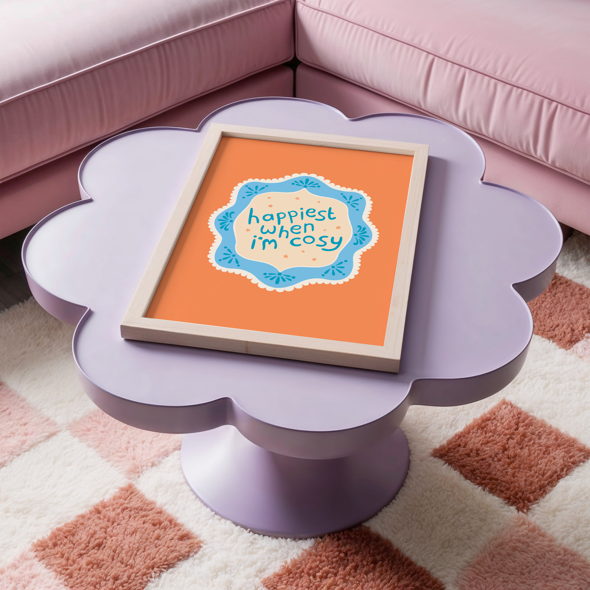 An orange print with a quote inside an illustrated blue decorative border - which says 'happiest when I'm cosy'.