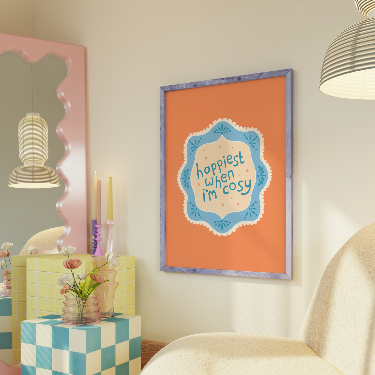 An orange print with a quote inside an illustrated blue decorative border - which says 'happiest when I'm cosy'.