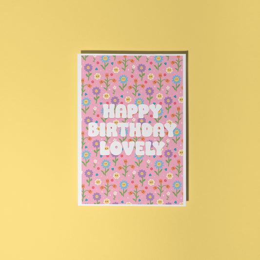 A pink floral birthday card, with white text that reads 'Happy Birthday Lovely'.
