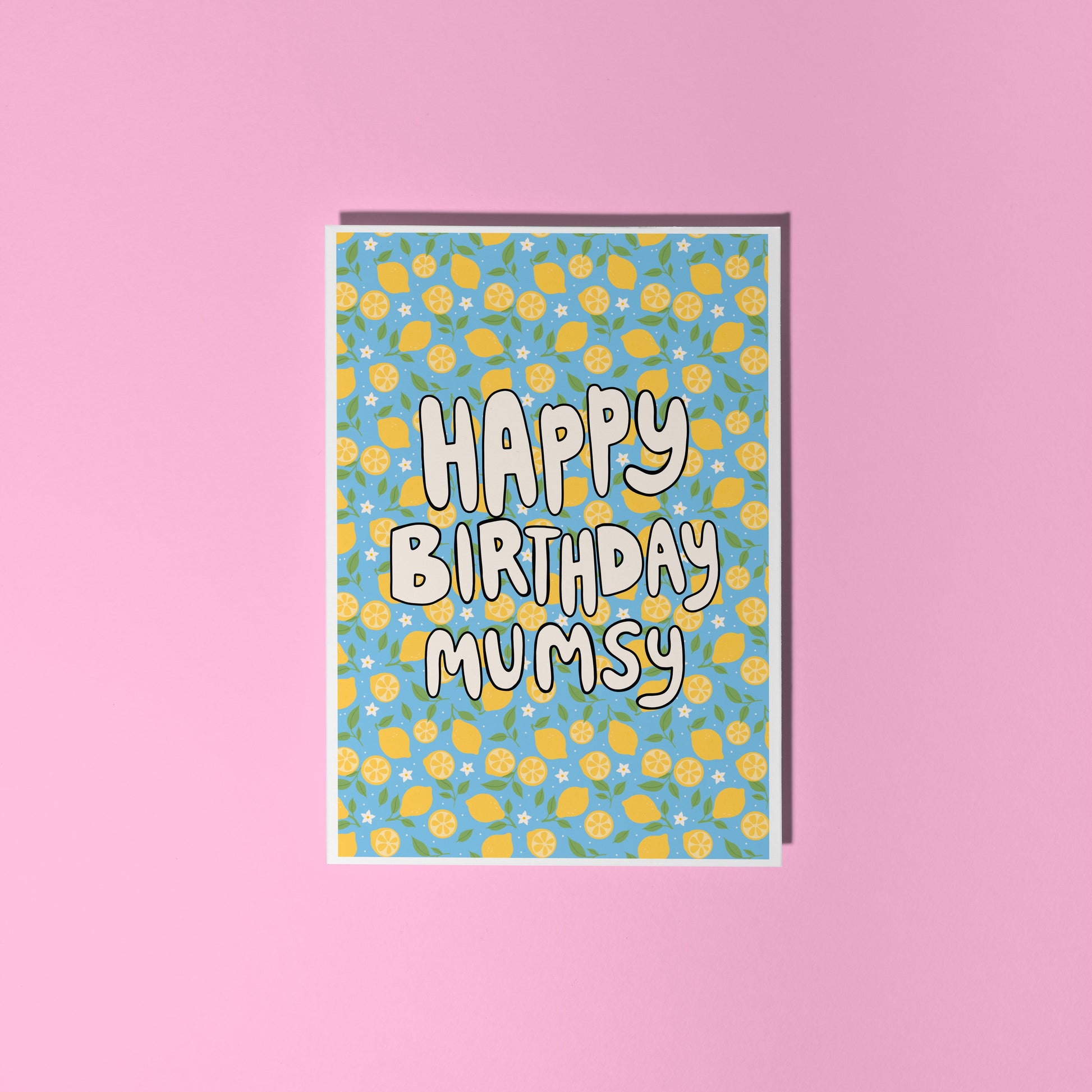 A blue card with a lemon pattern, and white chunky text that reads 'Happy Birthday Mumsy' in the centre.