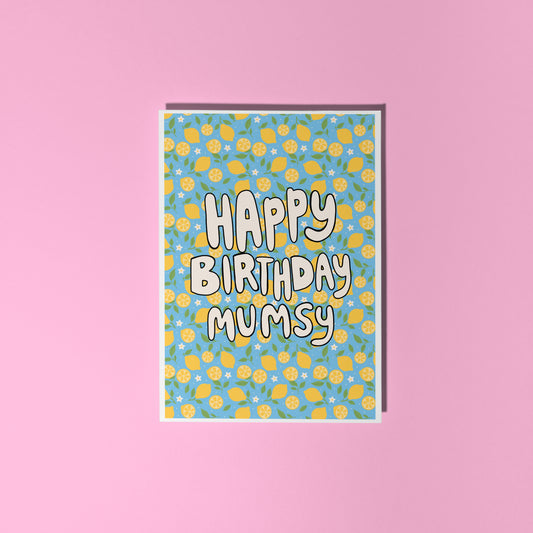 A blue card with a lemon pattern, and white chunky text that reads 'Happy Birthday Mumsy' in the centre.