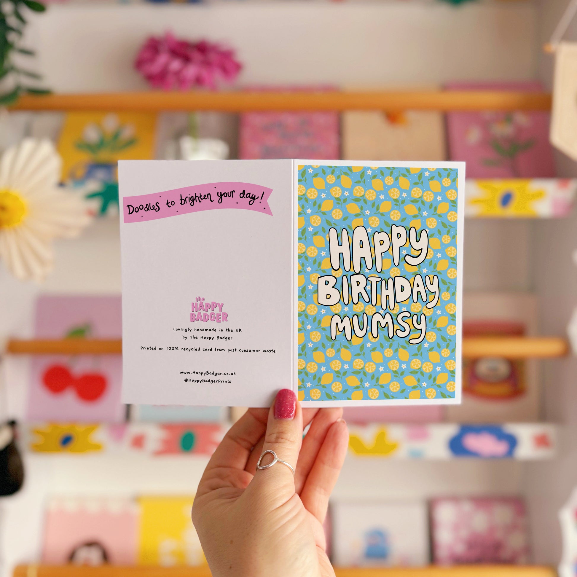 A blue card with a lemon pattern, and white chunky text that reads 'Happy Birthday Mumsy' in the centre.